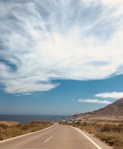 Empty road along countryside landscape