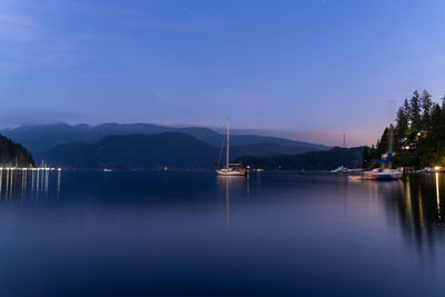 Scenic view of lake against sky at night