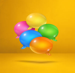 Close-up of multi colored balloons against yellow background