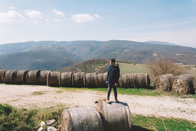 Full length of woman standing on mountain landscape