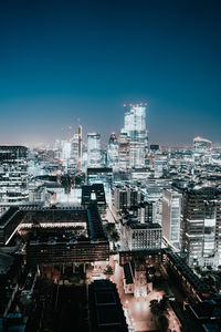 High angle view of illuminated buildings against clear sky