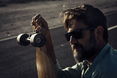 Young man photographing with camera