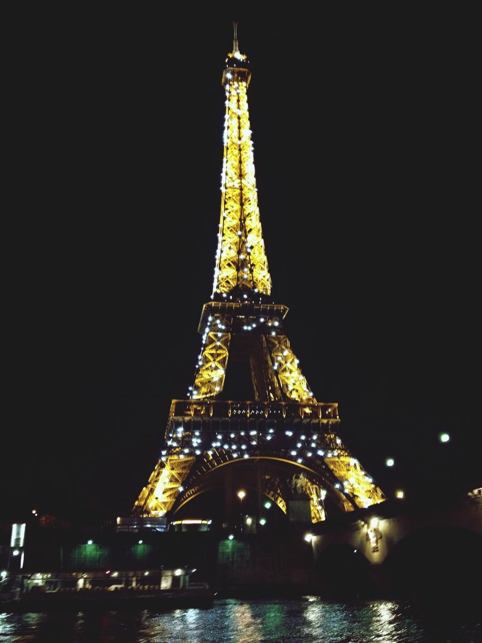 illuminated, night, architecture, built structure, travel destinations, famous place, international landmark, capital cities, tourism, water, travel, city, building exterior, sky, low angle view, tower, clear sky, eiffel tower, tall - high, river