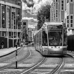 View of railroad tracks in city against sky