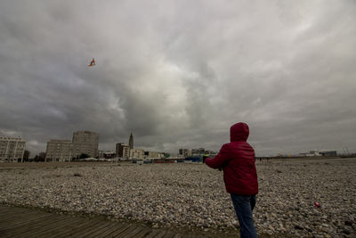 Rear view of man standing on beach