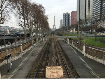 High angle view of railroad tracks leading towards eiffel tower in city