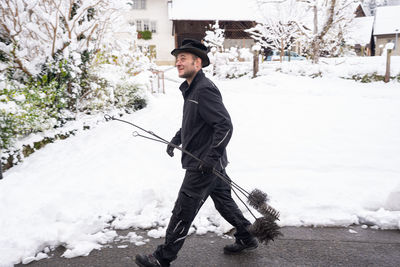Full length of man standing on snow covered field