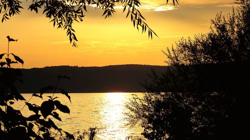Scenic view of calm lake at sunset