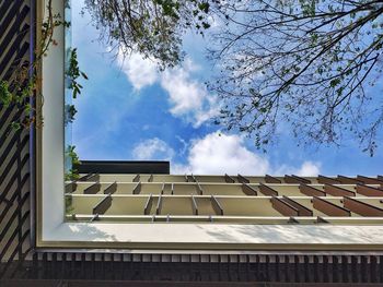 Low angle view of building against cloudy sky