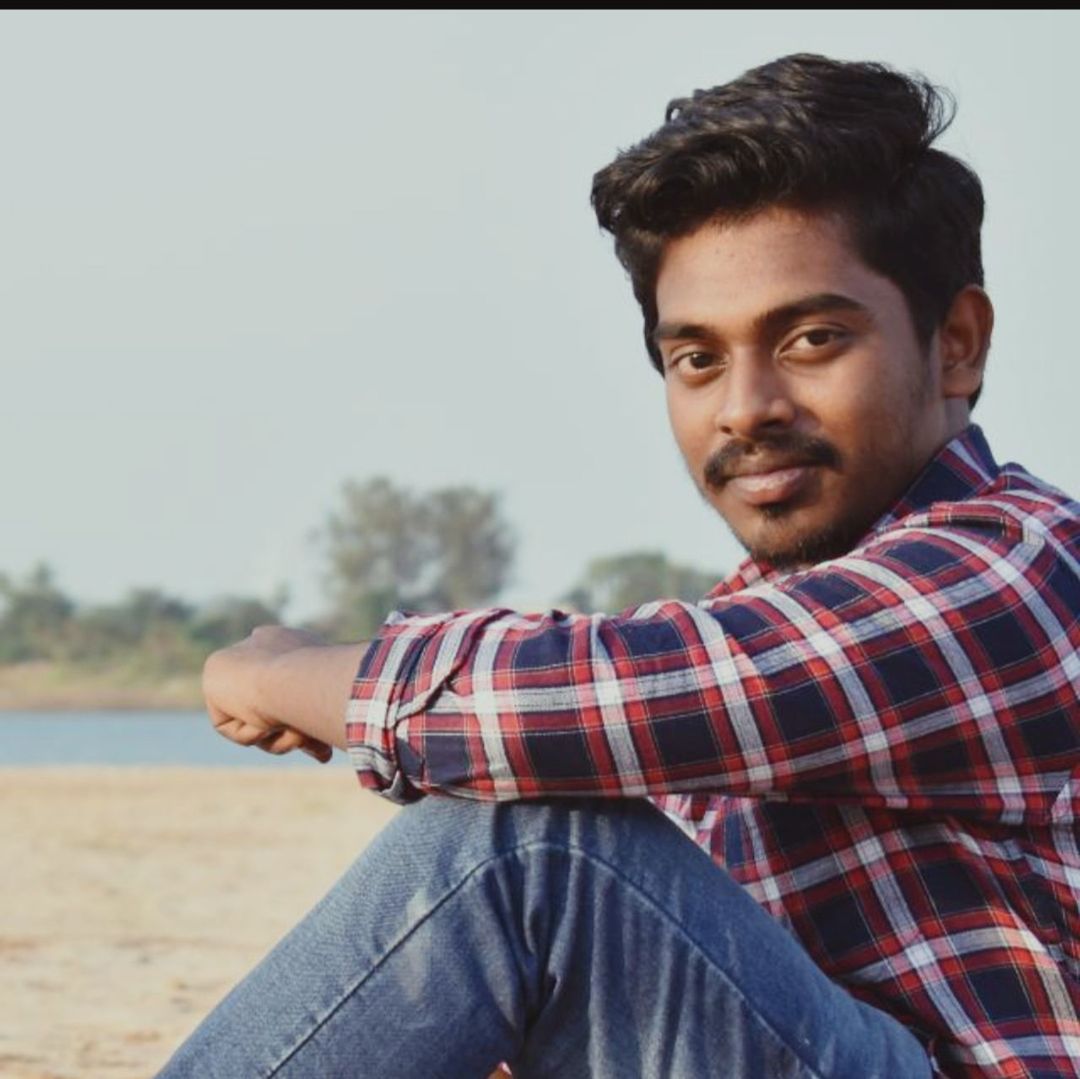 one person, men, young adult, adult, casual clothing, portrait, photo shoot, beard, relaxation, looking at camera, facial hair, pattern, leisure activity, nature, sitting, copy space, checked pattern, sky, looking, lifestyles, emotion, beach, land, day, smiling, person, outdoors, focus on foreground, contemplation, happiness, jeans, portrait photography, clothing, black hair, stubble
