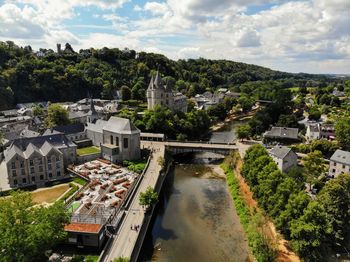 High angle view of river amidst buildings against sky