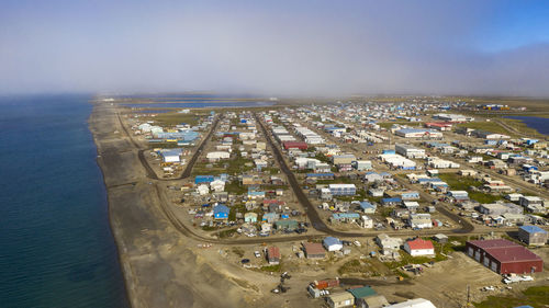 High angle view of sea and cityscape against sky