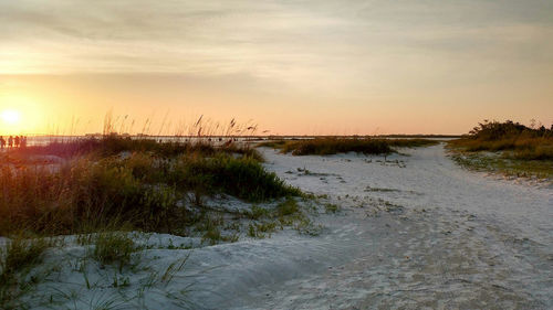 Scenic view of beach against sky during sunset