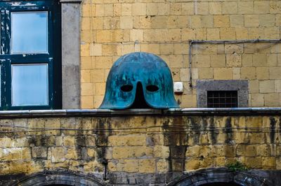 Close-up of helmet against stone wall