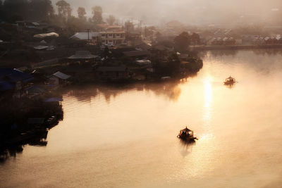 Scenic view of lake against houses in town