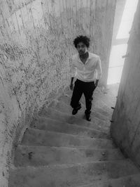 Rear view of boy walking in abandoned building