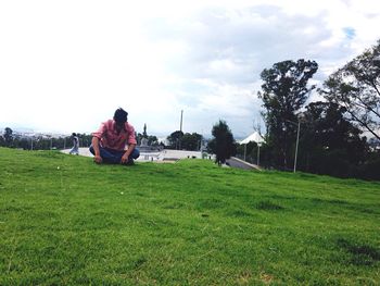 People relaxing on grassy field