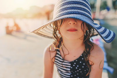 Close-up of girl wearing hat at beach