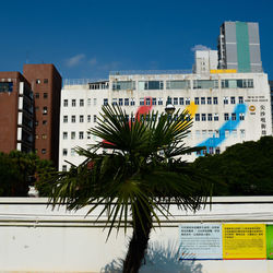 Buildings in city against blue sky