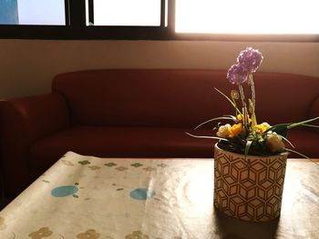 Close-up of vase on window at home