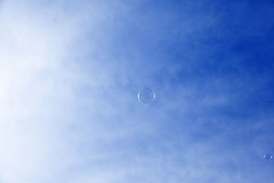 Low angle view of balloons against blue sky