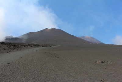 Scenic view of arid landscape against sky