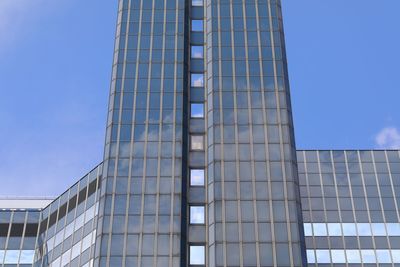 Low angle view of modern building against clear blue sky