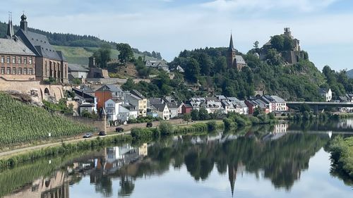 Reflection of buildings and trees in river