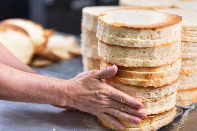 Close-up of hand holding bread on table