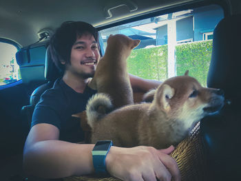 Young woman with dog in car