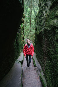 Full length portrait of man standing in forest