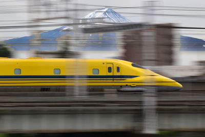 Blurred motion of train at railroad station