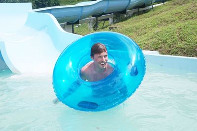 Portrait of happy boy playing in swimming pool