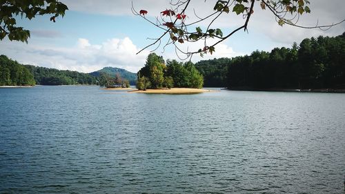 Scenic view of river against cloudy sky