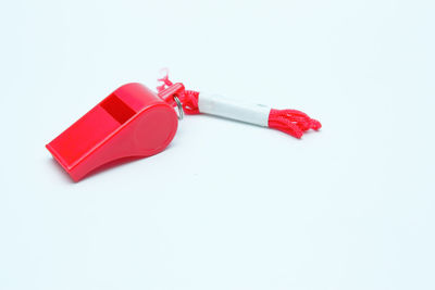 High angle view of red telephone over white background