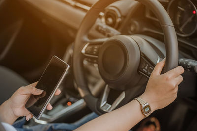 Midsection of man using mobile phone