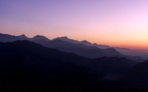 Scenic view of silhouette mountains against sky during sunset