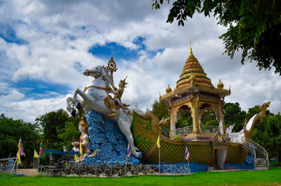 Statue of temple against building