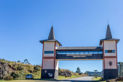 Low angle view of built structure against clear blue sky