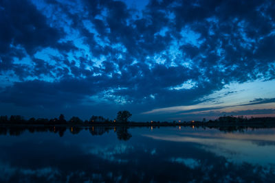 Dark clouds in the evening sky reflecting in the lake water