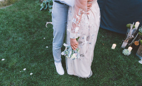 High angle view of newlywed couple embracing on field