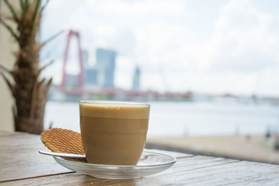 Coffee cup and cookie in plate on table