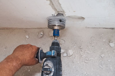 Close-up of man working against wall