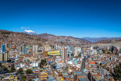 High angle view of townscape against clear blue sky