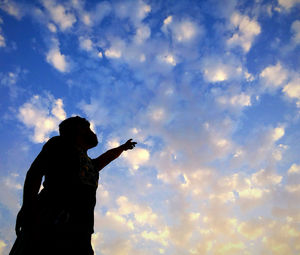 Low angle view of statue against cloudy sky