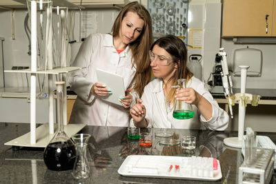 Young woman using smart phone on table