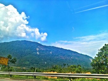 Scenic view of mountains against blue sky