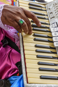 Midsection of man playing piano