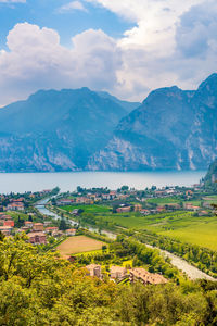 Scenic view of lake and field against mountain