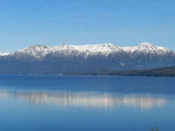 Scenic view of lake and snowcapped mountains against sky